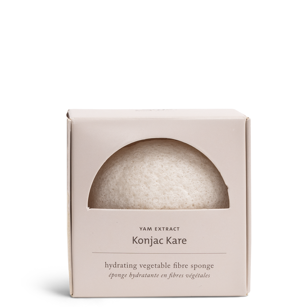 Konjac hydrating vegetable fibre sponge in its packaging, showing a crescent moon piece of the circular sponge
